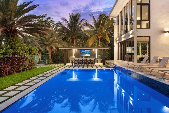 a view of a house with swimming pool and sitting area