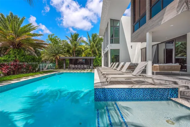 a view of house with swimming pool outdoor seating