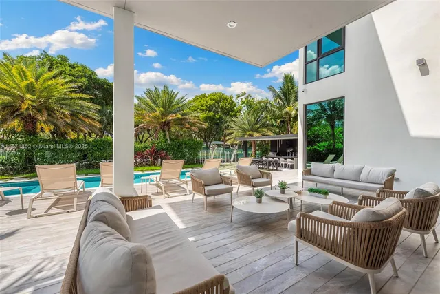 a view of a patio with couches chairs and potted plants