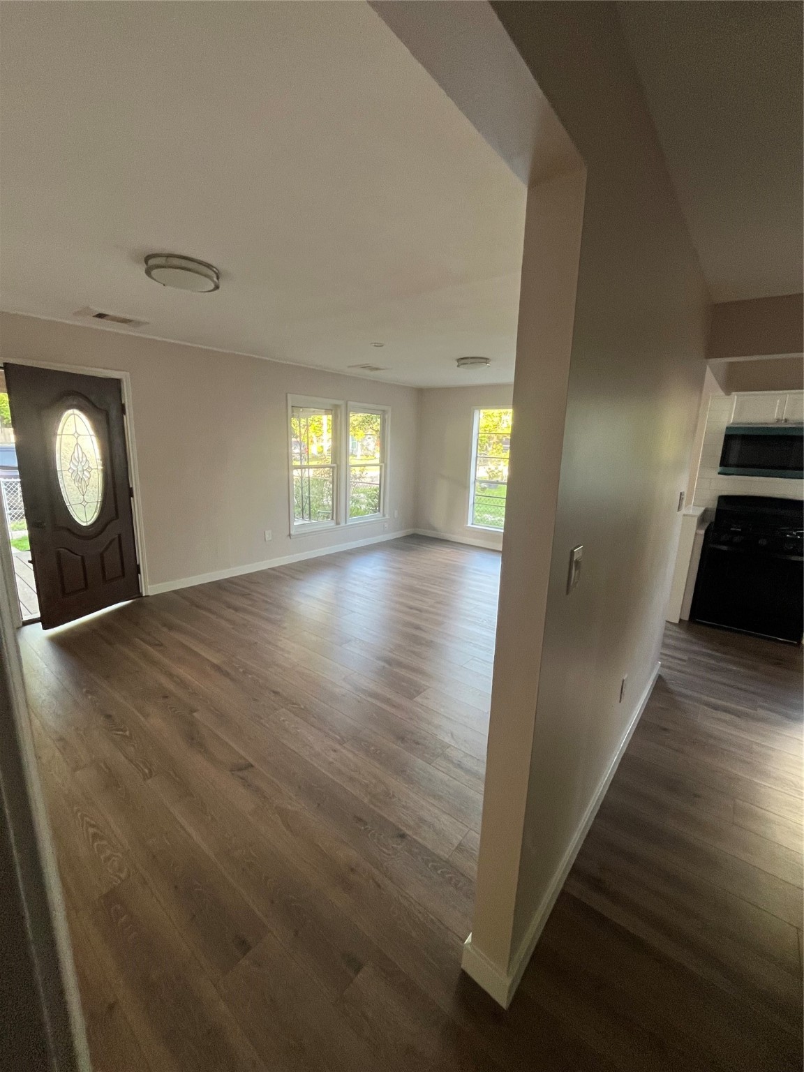 Spacious living room features an open layout with abundant natural light, perfect for both relaxing and entertaining.