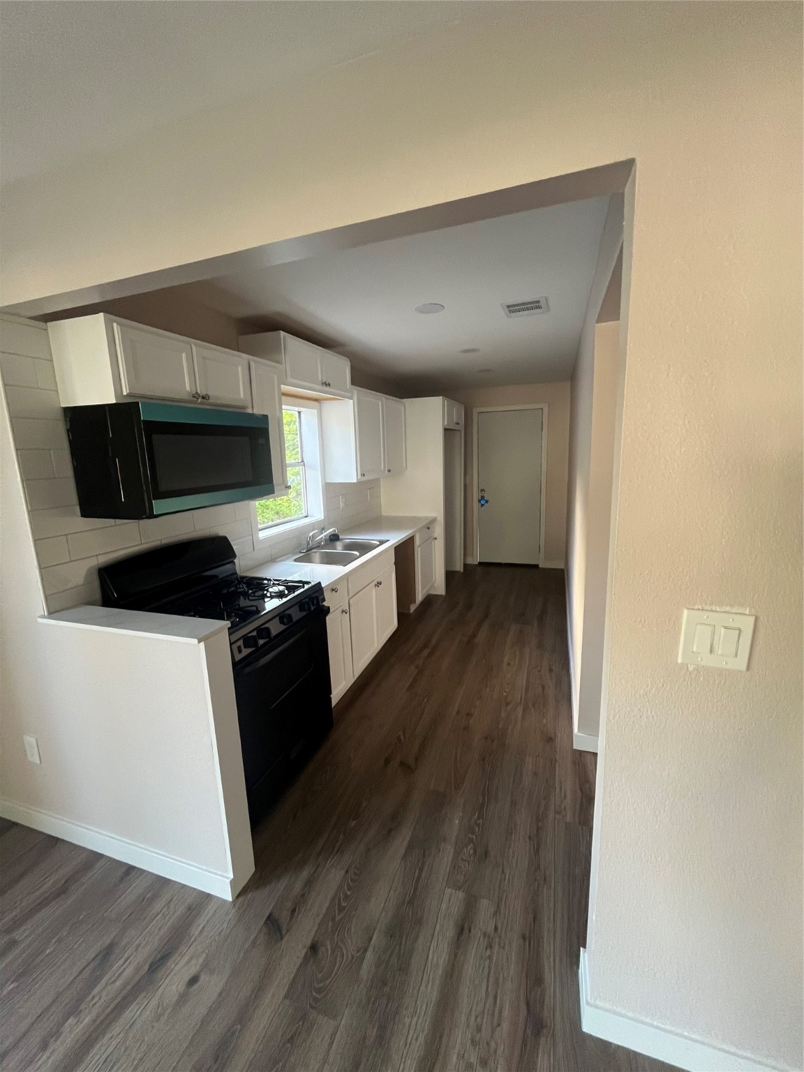 222 East Adoue Avenue Baytown, TX 77520 - Photo 3 of 8 This updated kitchen boasts modern finishes, sleek countertops, and space for style and functionality.