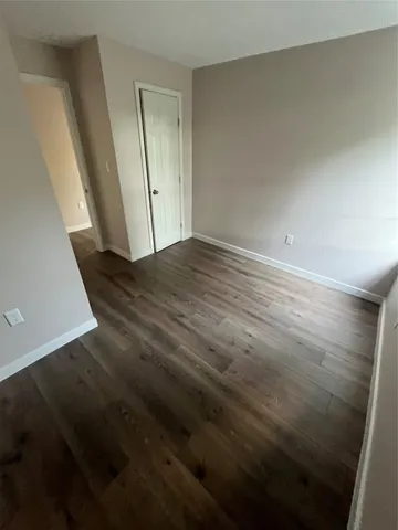 an empty room with wooden floor