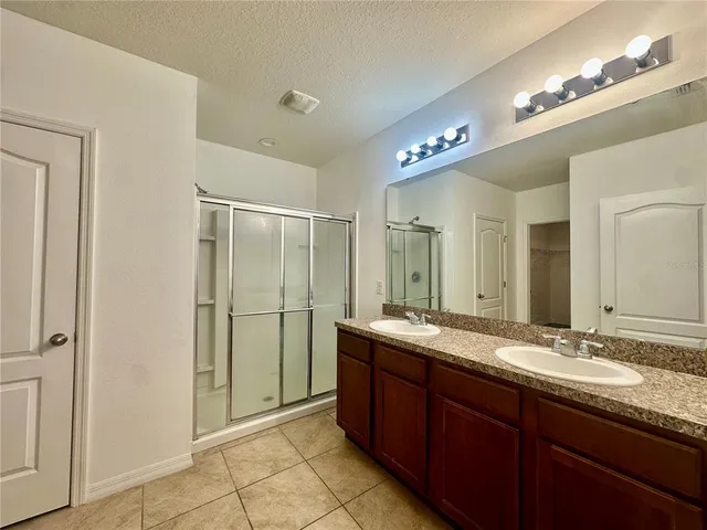 a bathroom with a granite countertop sink mirror and double