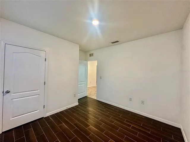 a view of room with window and wooden floor