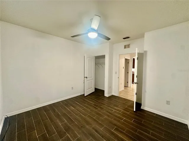 a view of an empty room and wooden floor
