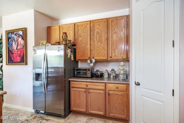 a kitchen with stainless steel appliances a refrigerator and cabinets