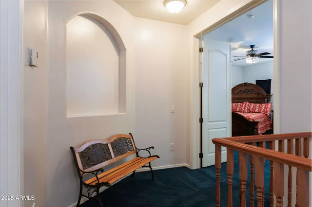 a living room with furniture and a bookshelf