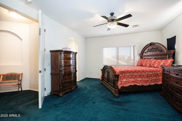 a bedroom with a bed and a ceiling fan