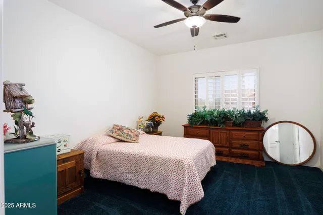 a bedroom with a bed and dresser