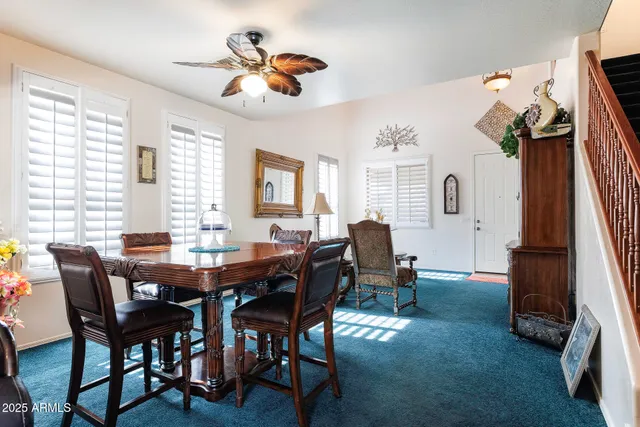 a view of a dining room with furniture and a chandelier