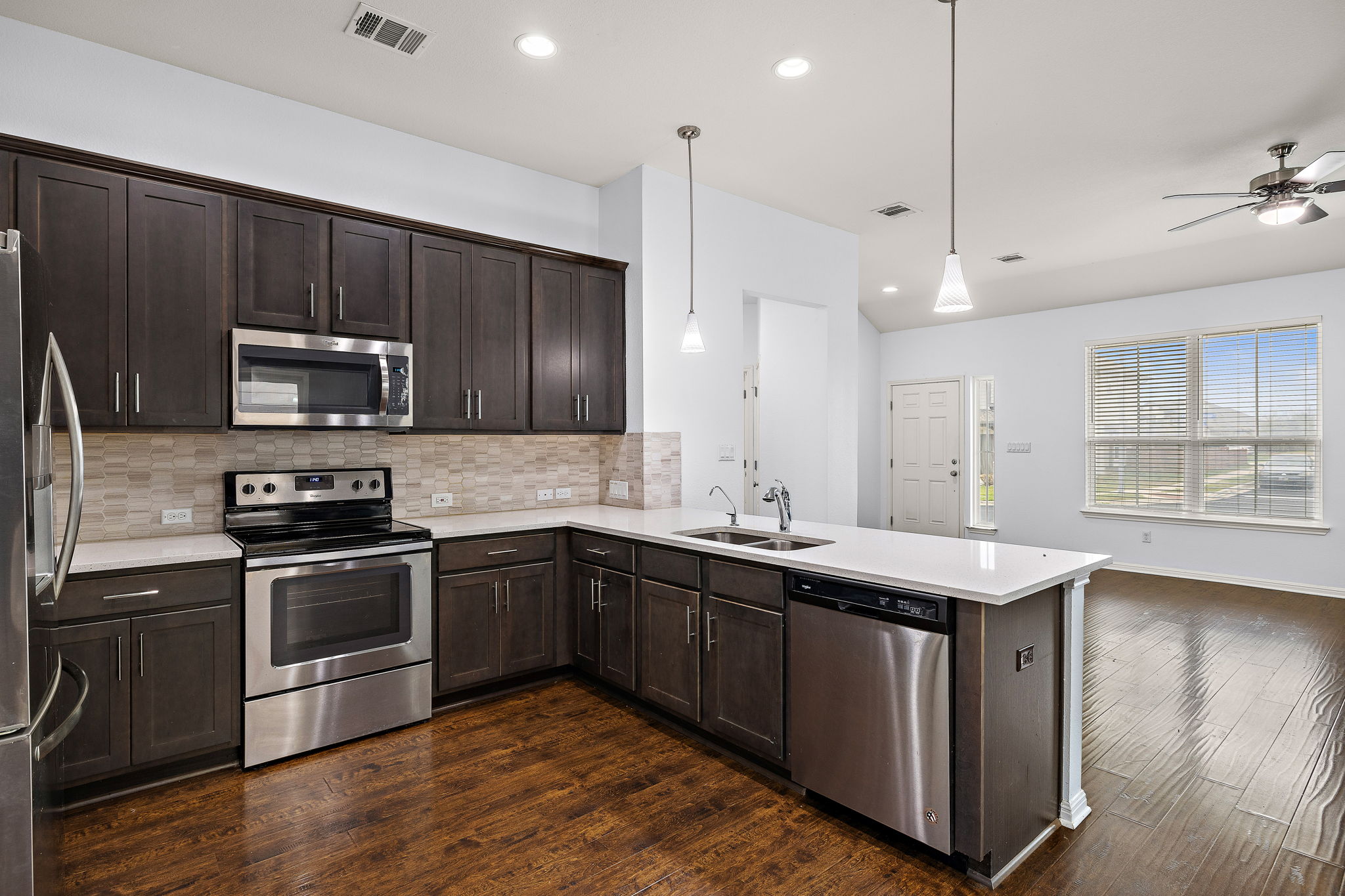 706 Coconut Grove Street Pflugerville, TX 78660 - Photo 12 of 23 Cook and gather in this stylish kitchen featuring rich cabinetry, stainless steel appliances, and elegant countertops designed for both beauty and function.