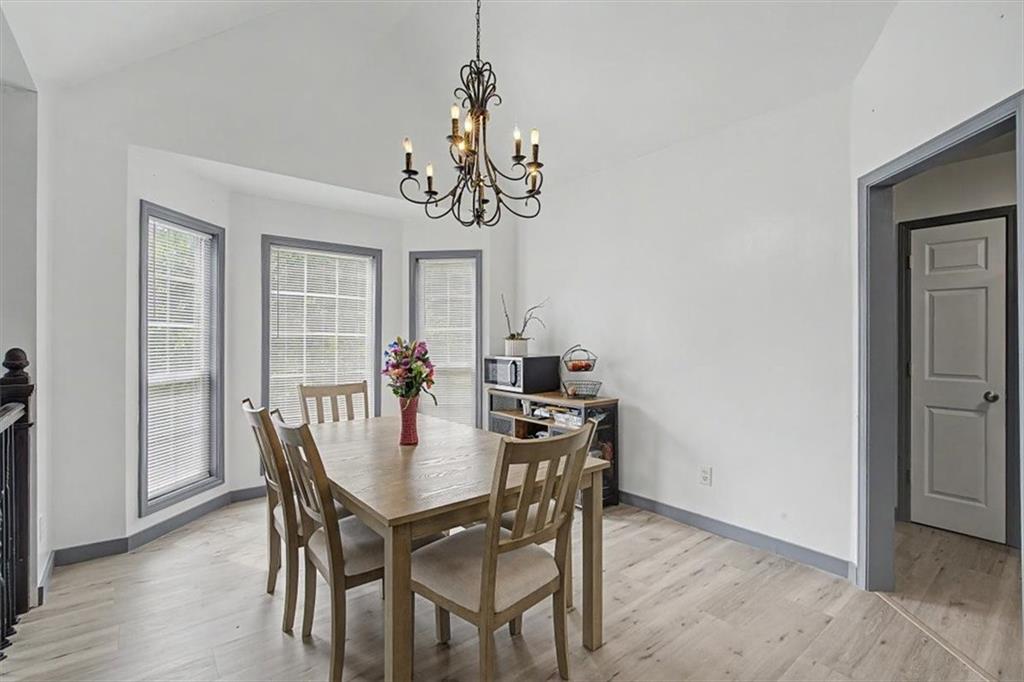 409 Windsor Way Canton, GA 30115 - Photo 11 of 51 a view of a dining room with furniture window and wooden floor