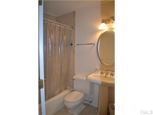 3 Fox Road Clarksville, VA 23927 - Photo 11 of 21 a bathroom with a toilet a sink and mirror