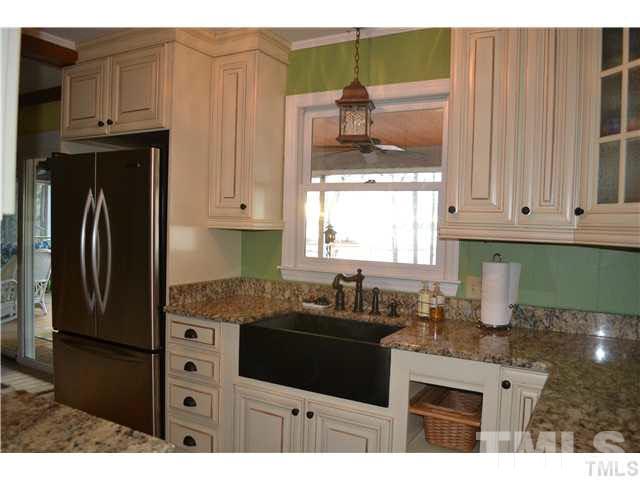 3 Fox Road Clarksville, VA 23927 - Photo 4 of 21 a kitchen with granite countertop a refrigerator a stove a sink and dishwasher with wooden floor