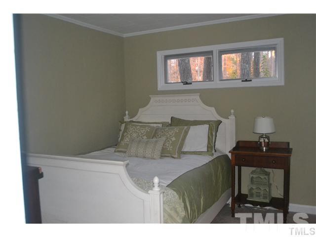 3 Fox Road Clarksville, VA 23927 - Photo 10 of 21 a bed sitting in a bedroom next to a window