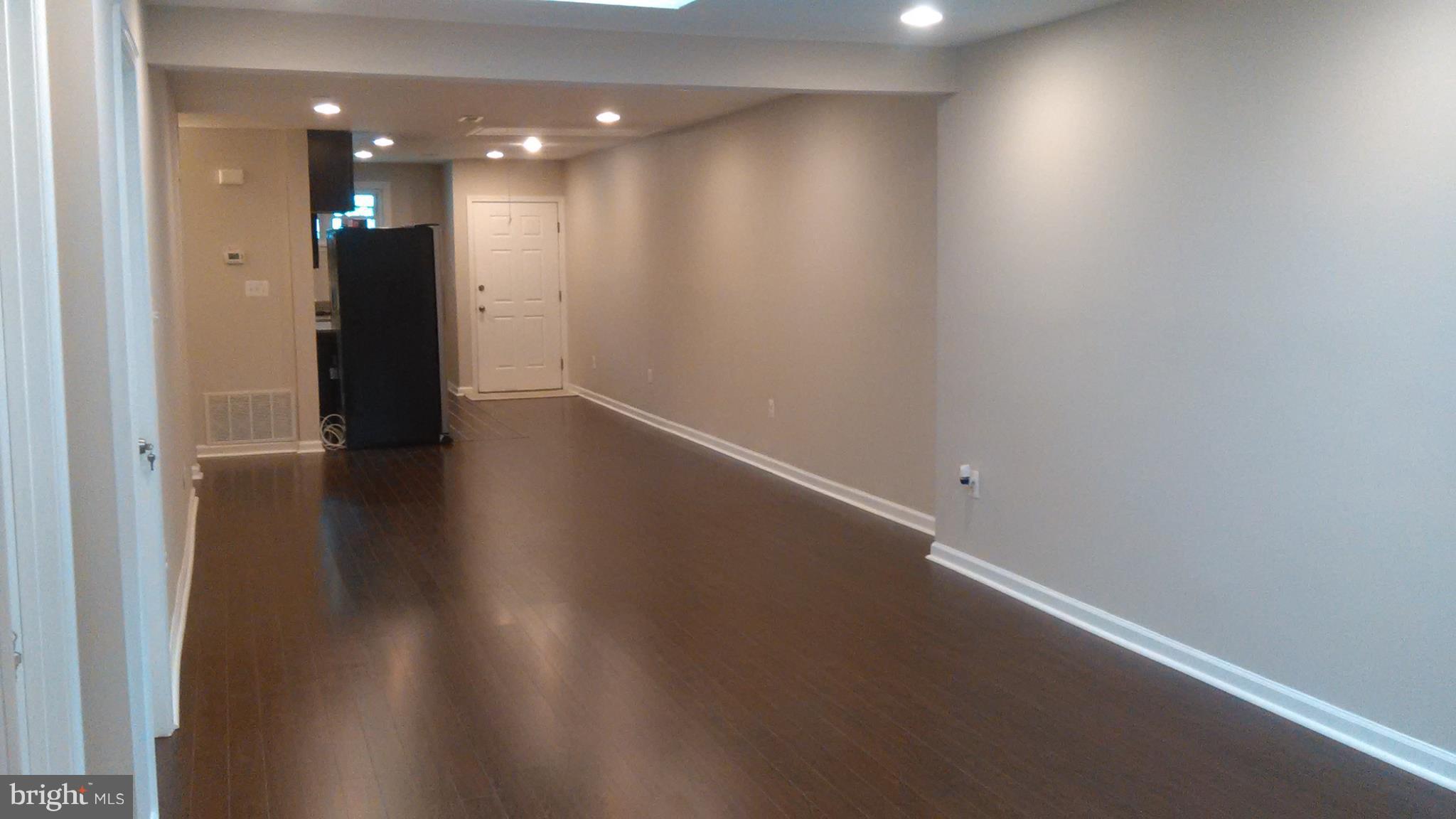 7701 Greenleaf Road Landover, MD 20785 - Photo 15 of 24 an empty room with wooden floor and windows