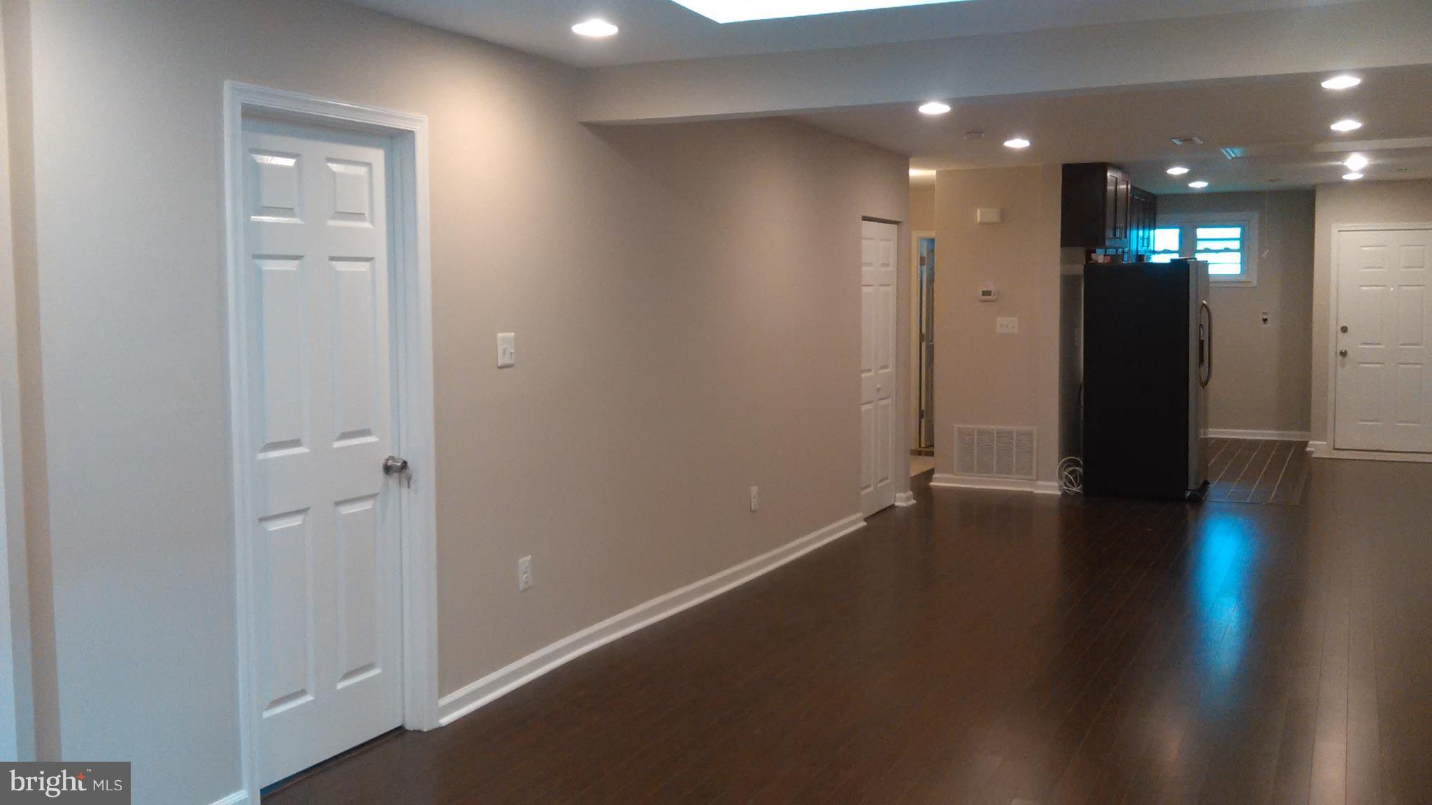 7701 Greenleaf Road Landover, MD 20785 - Photo 16 of 24 an empty room with wooden floor and windows