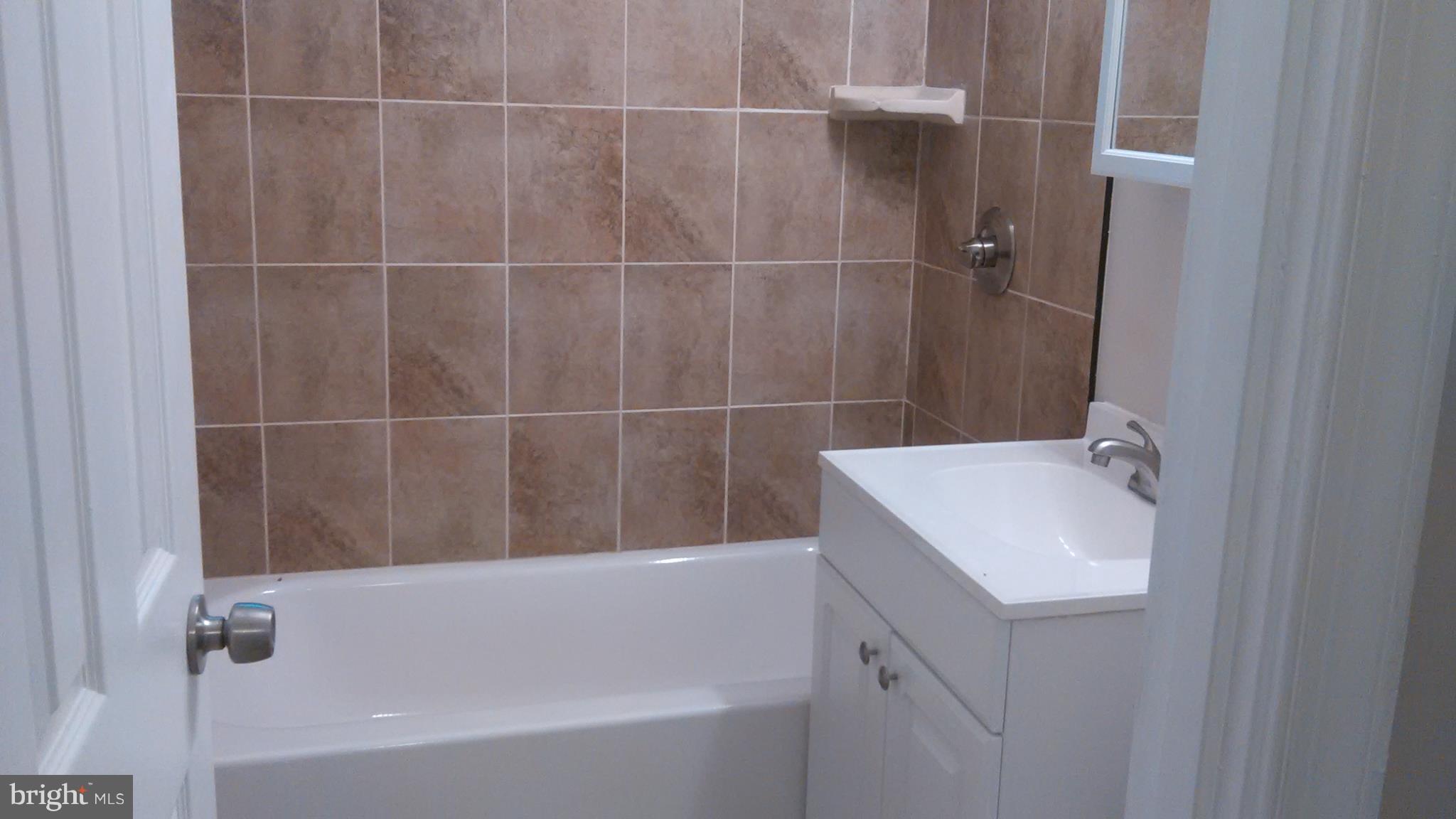 7701 Greenleaf Road Landover, MD 20785 - Photo 17 of 24 a bathroom with a bathtub and shower