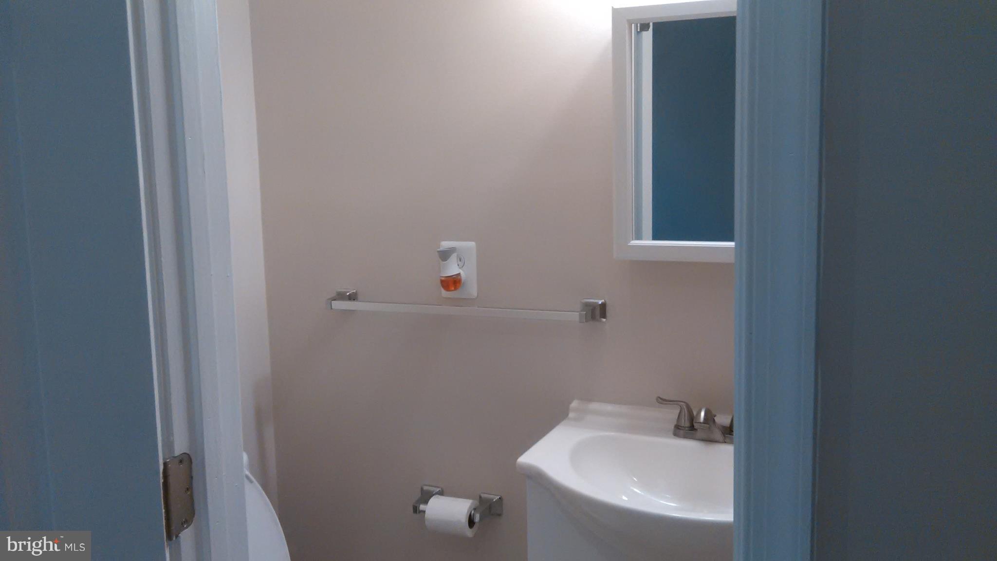 7701 Greenleaf Road Landover, MD 20785 - Photo 18 of 24 a bathroom with a sink and toilet