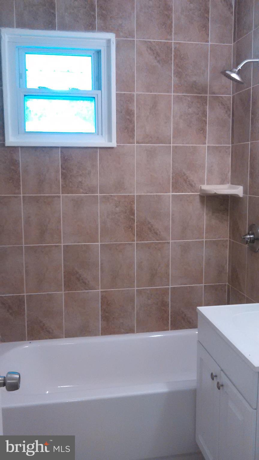 7701 Greenleaf Road Landover, MD 20785 - Photo 22 of 24 a bathroom with a bathtub and a shower