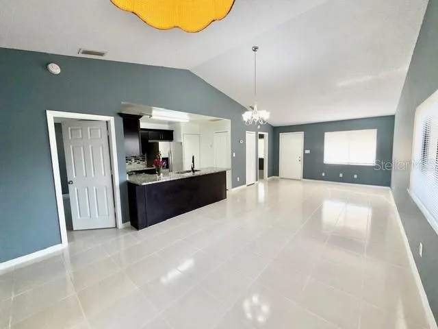 a view of a kitchen with a sink and a refrigerator