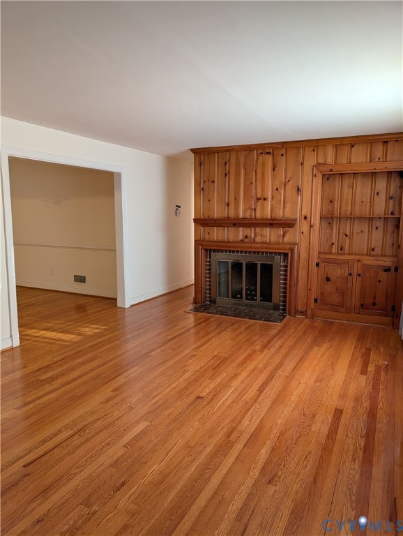 5915 Ridge Road Richmond, VA 23227 - Photo 3 of 17 an empty room with wooden floor fireplace and windows