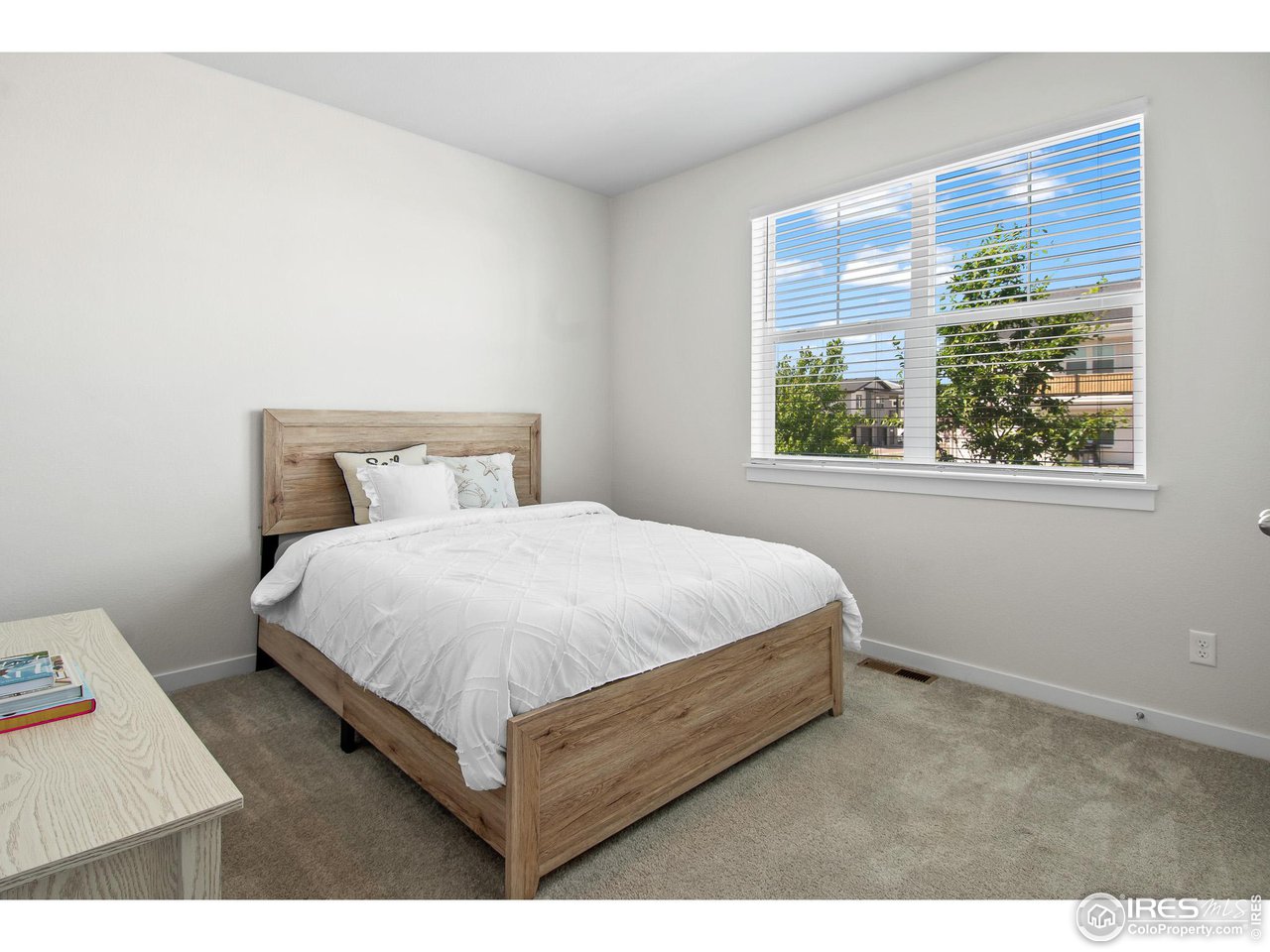2107 Setting Sun Drive Windsor, CO 80550 - Photo 15 of 40 a bed sitting in a bedroom next to a window