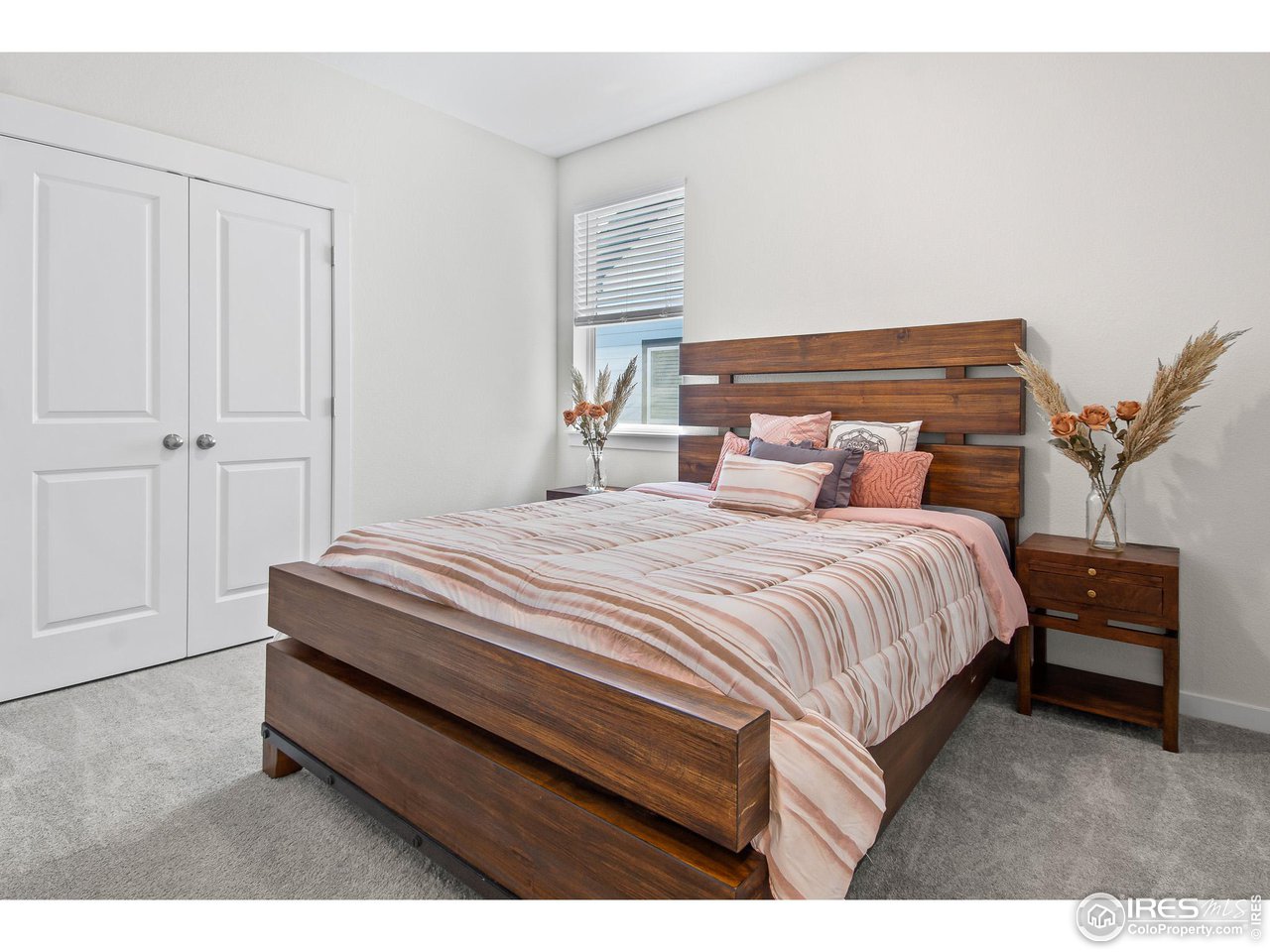 2107 Setting Sun Drive Windsor, CO 80550 - Photo 18 of 40 a bedroom with a bed and a potted plant