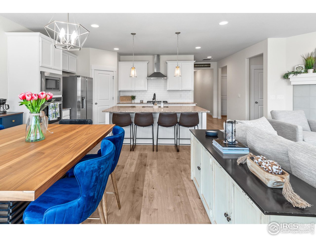 2107 Setting Sun Drive Windsor, CO 80550 - Photo 22 of 40 a kitchen with a table and chairs