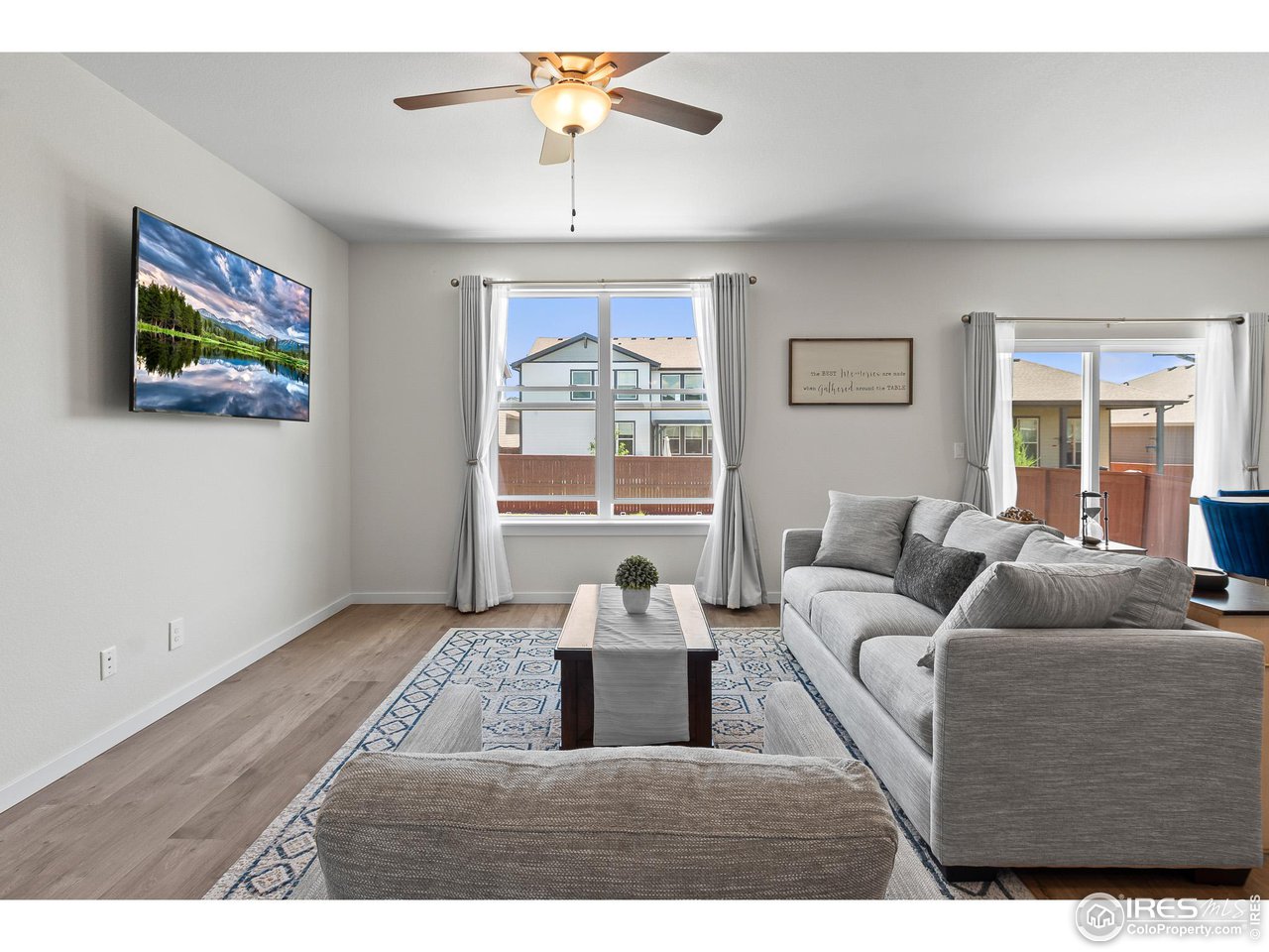 2107 Setting Sun Drive Windsor, CO 80550 - Photo 27 of 40 a living room with furniture and a large window