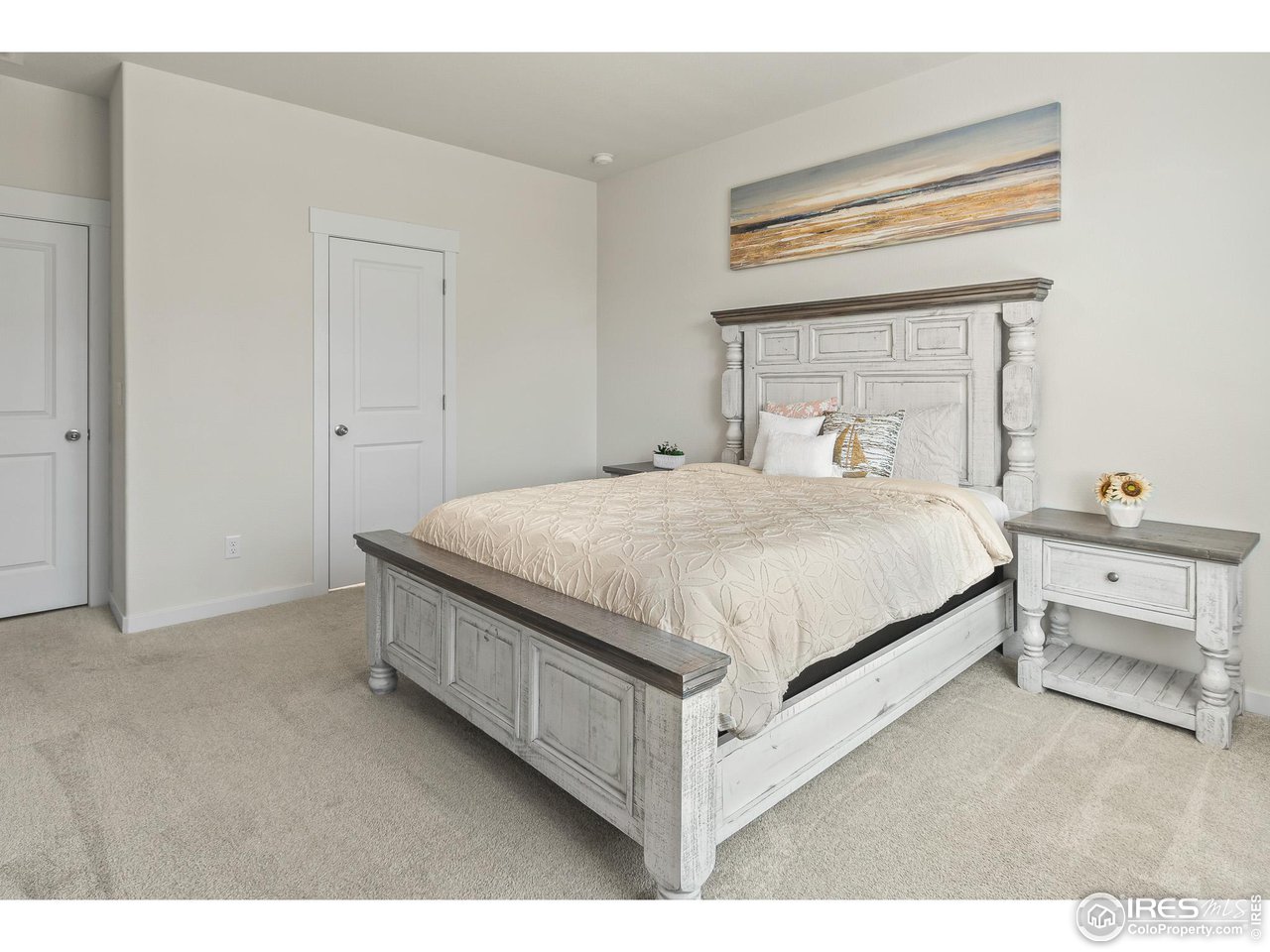 2107 Setting Sun Drive Windsor, CO 80550 - Photo 30 of 40 a bedroom with a bed and a dresser