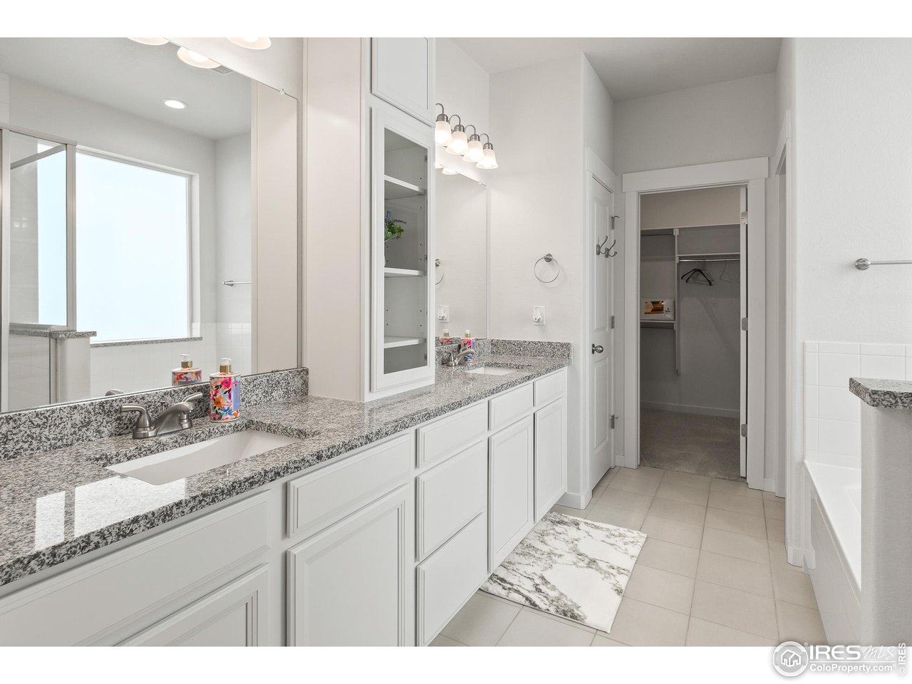2107 Setting Sun Drive Windsor, CO 80550 - Photo 33 of 40 a bathroom with a sink and a mirror