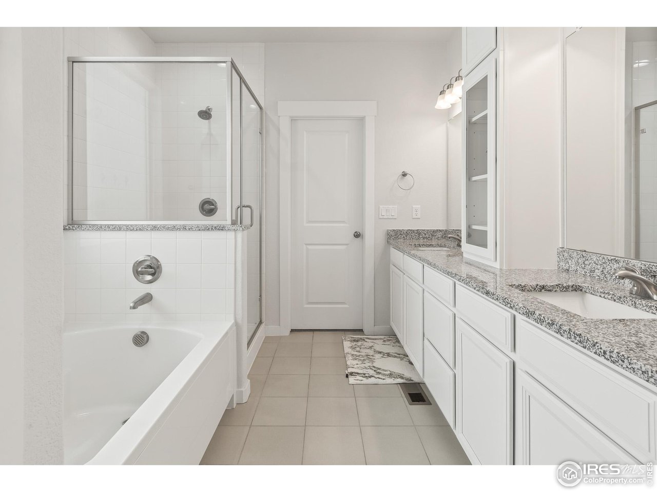 2107 Setting Sun Drive Windsor, CO 80550 - Photo 35 of 40 a bathroom with a granite countertop sink a mirror a bathtub and shower