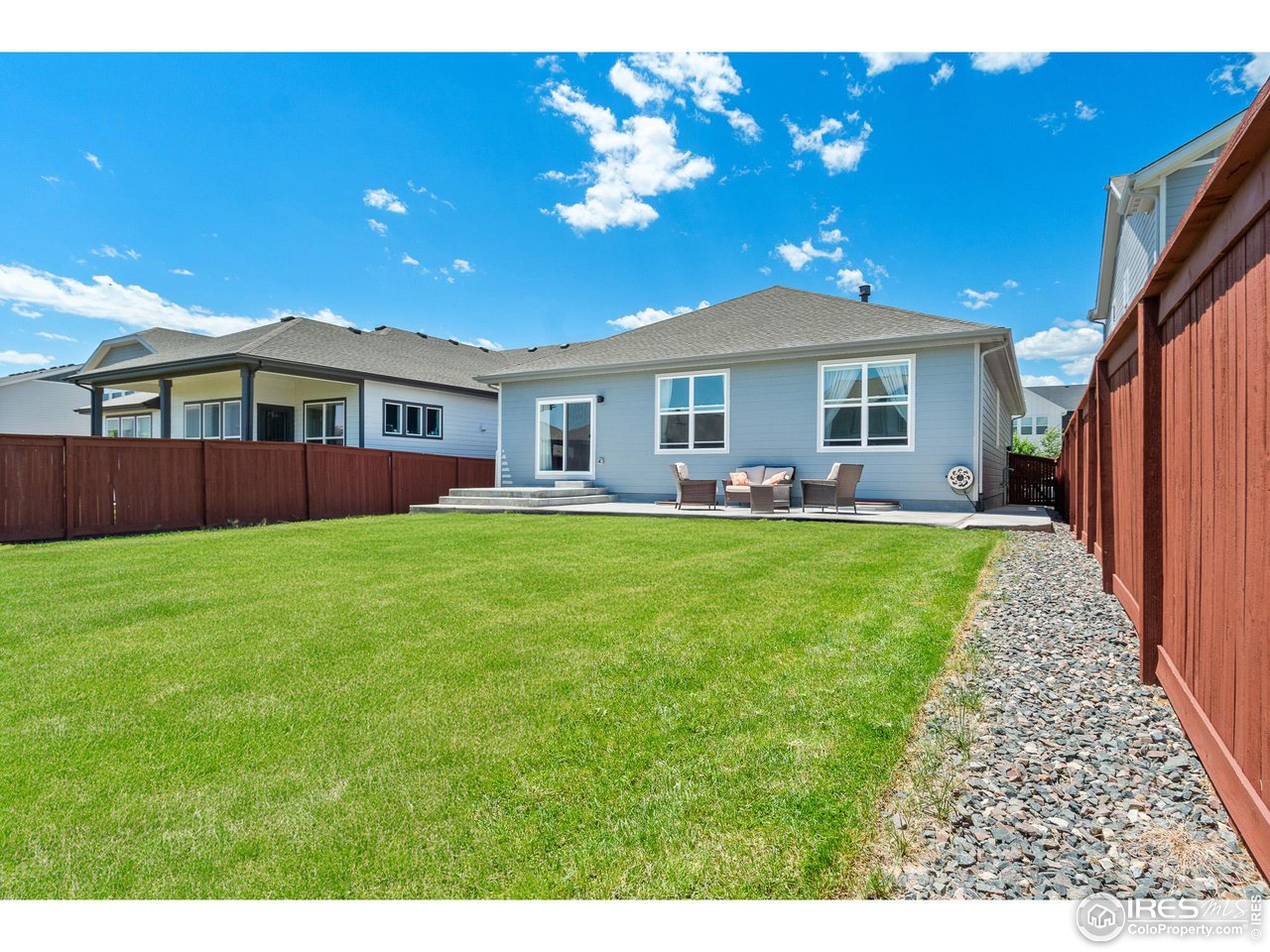 2107 Setting Sun Drive Windsor, CO 80550 - Photo 39 of 40 a front view of a house with a garden and yard