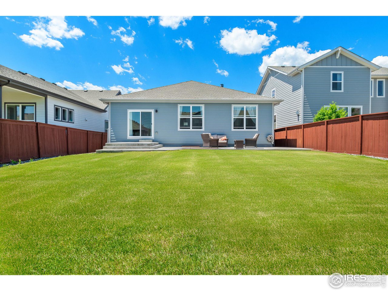 2107 Setting Sun Drive Windsor, CO 80550 - Photo 40 of 40 a view of a yard in front of a house with a large tree