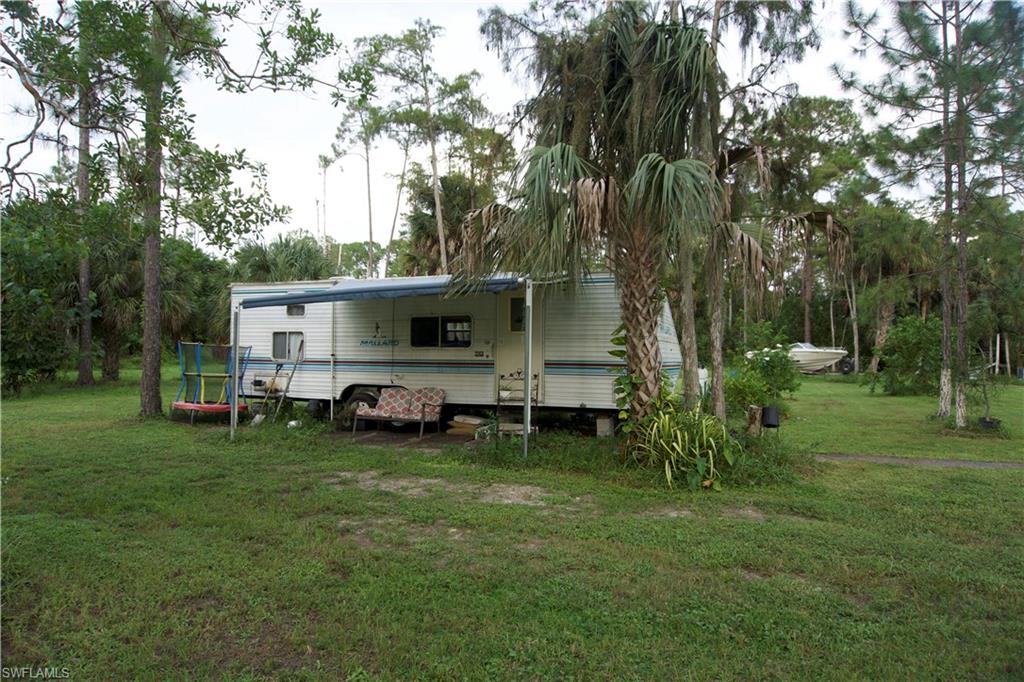 2407 Randall Boulevard Naples, FL 34120 - Photo 14 of 46 a view of a house with a yard