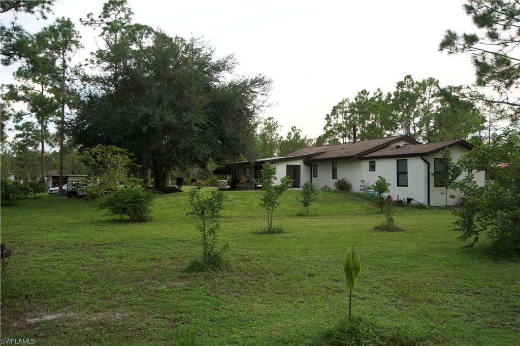 2407 Randall Boulevard Naples, FL 34120 - Photo 17 of 46 a front view of a house with a yard