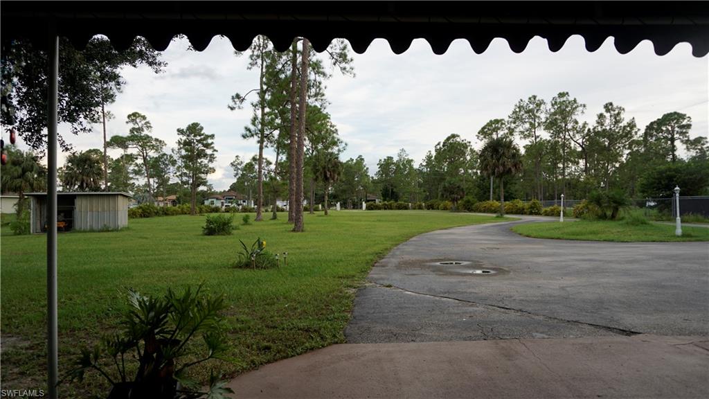 2407 Randall Boulevard Naples, FL 34120 - Photo 21 of 46 a view of a house with a big yard and trees