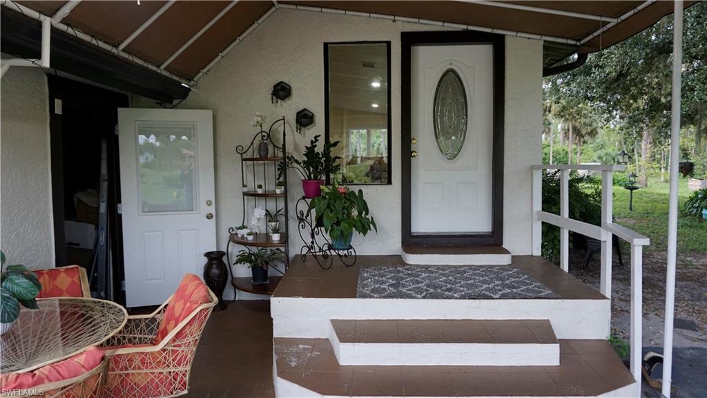 2407 Randall Boulevard Naples, FL 34120 - Photo 22 of 46 a front view of a house with garden