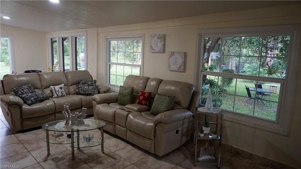 2407 Randall Boulevard Naples, FL 34120 - Photo 24 of 46 a living room with furniture and a window