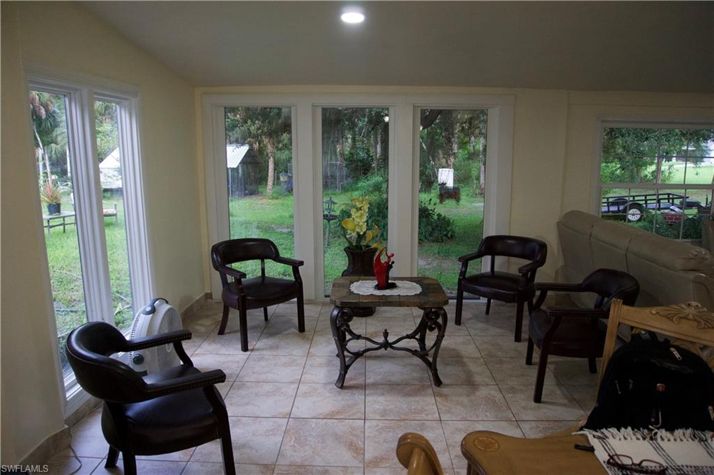 2407 Randall Boulevard Naples, FL 34120 - Photo 26 of 46 a living room filled with furniture and a large window