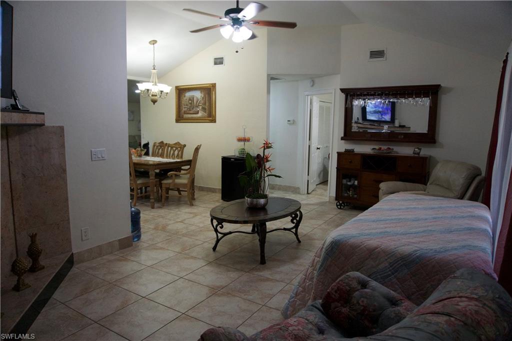 2407 Randall Boulevard Naples, FL 34120 - Photo 31 of 46 a living room with furniture a couch and a flat screen tv