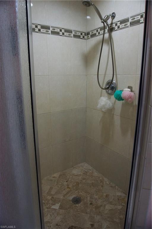 2407 Randall Boulevard Naples, FL 34120 - Photo 38 of 46 a bathroom with a shower