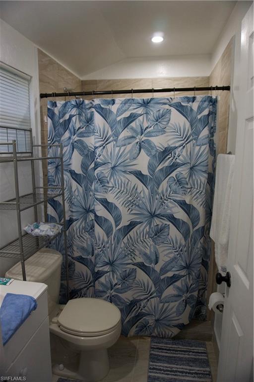 2407 Randall Boulevard Naples, FL 34120 - Photo 42 of 46 a bathroom with a toilet and a shower