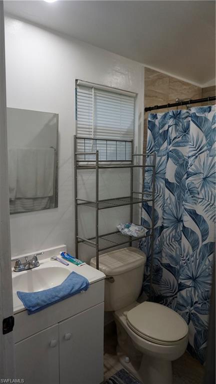 2407 Randall Boulevard Naples, FL 34120 - Photo 43 of 46 a bathroom with a sink toilet vanity and shower