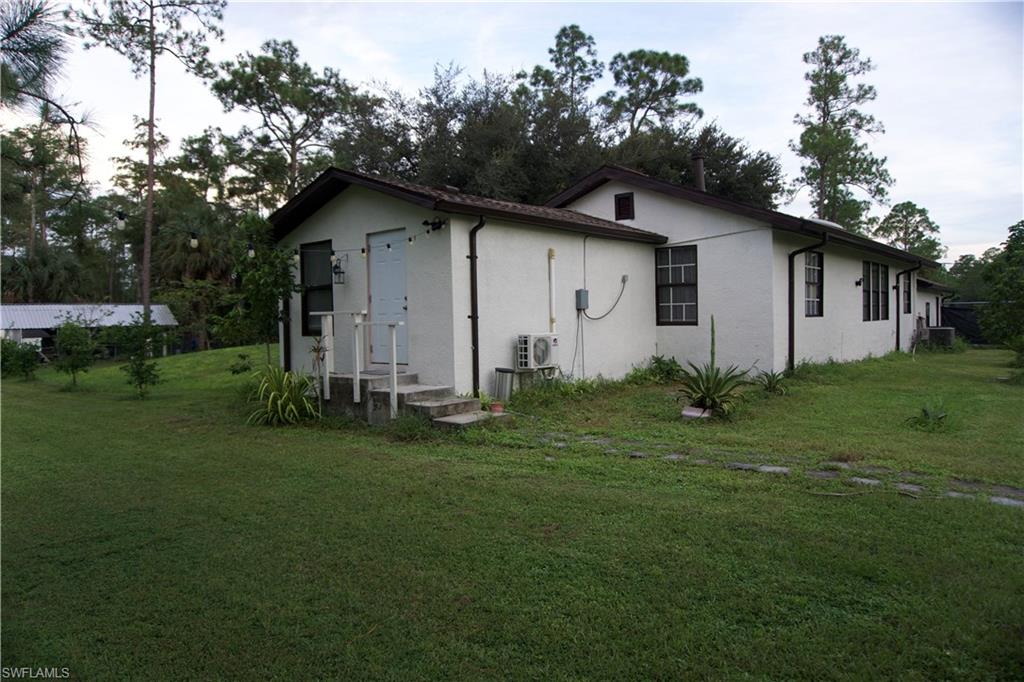 2407 Randall Boulevard Naples, FL 34120 - Photo 45 of 46 a house view with a garden space