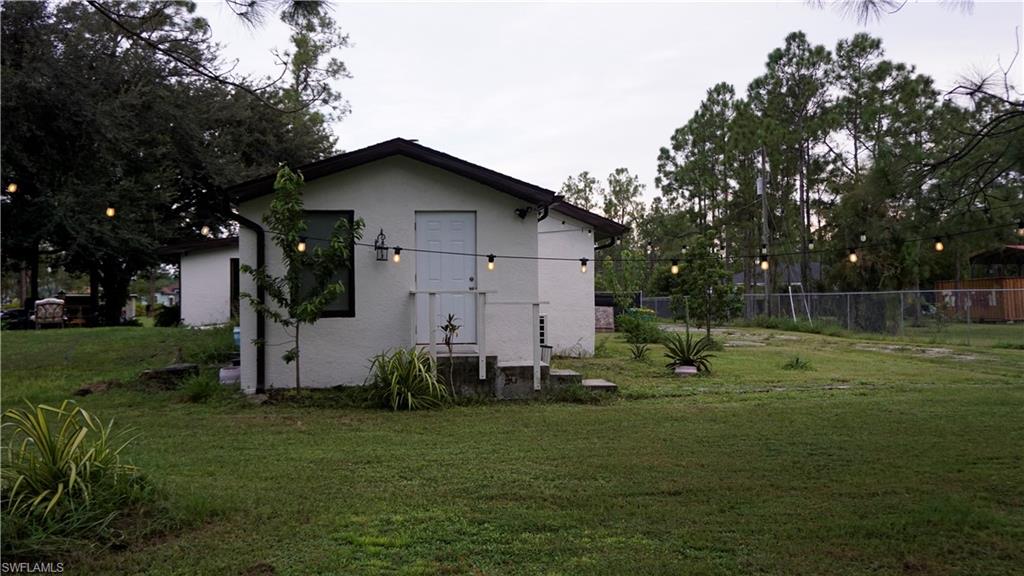 2407 Randall Boulevard Naples, FL 34120 - Photo 46 of 46 a backyard of a house with lots of green space