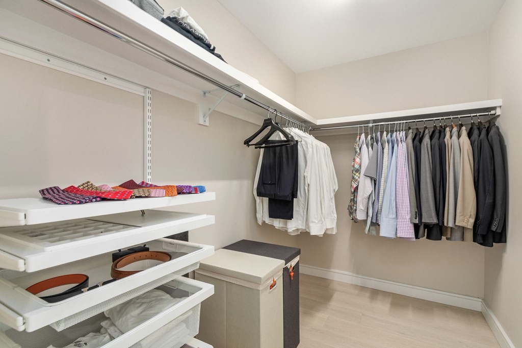 110 Broad Street, Unit 501 Boston, MA 02110 - Photo 11 of 41 a view of walk in closet with clothes and shoes