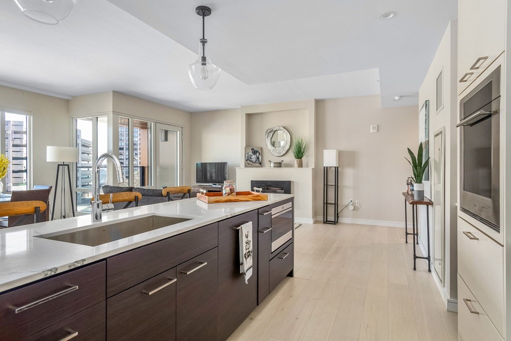 110 Broad Street, Unit 501 Boston, MA 02110 - Photo 16 of 41 a view of a kitchen center island cabinets and stainless steel appliances