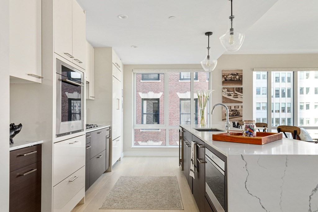 110 Broad Street, Unit 501 Boston, MA 02110 - Photo 18 of 41 a kitchen that has a lot of cabinets in it